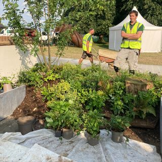 Andrew O'Donoghue of Gardens Revived building the hugelkultur mound for Zoe Claymore's Renter's Retreat garden at the 2023 Hampton Court Palace Garden Festival
