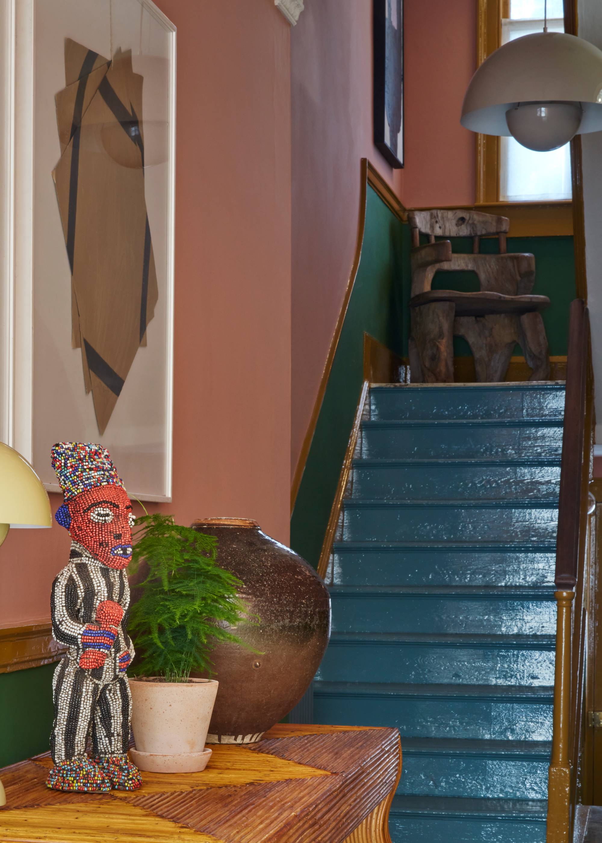 dark blue painted stairs with pink and green hallway