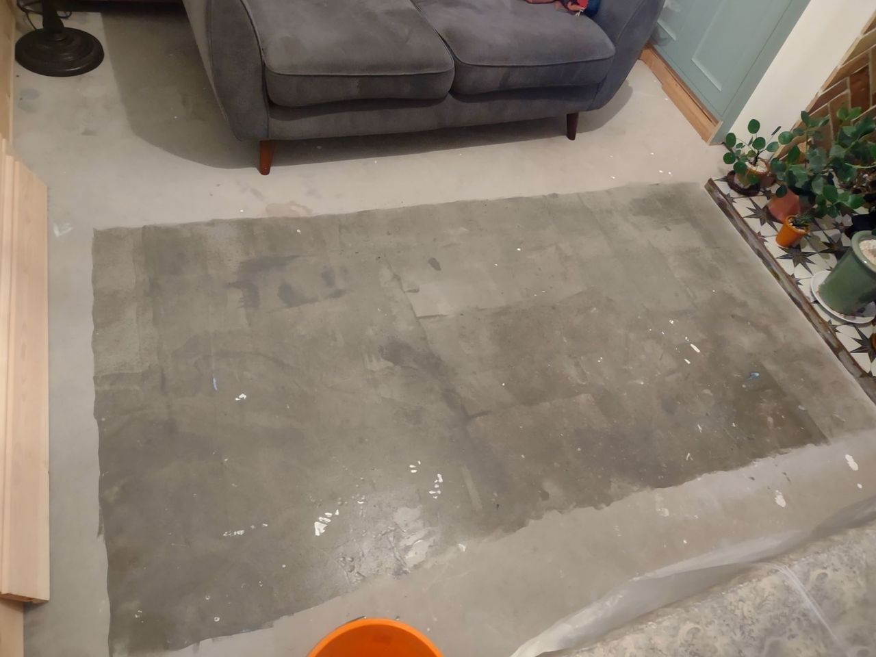 The subfloor after the primer has been rollered on but before the wooden herringbone slats have been laid