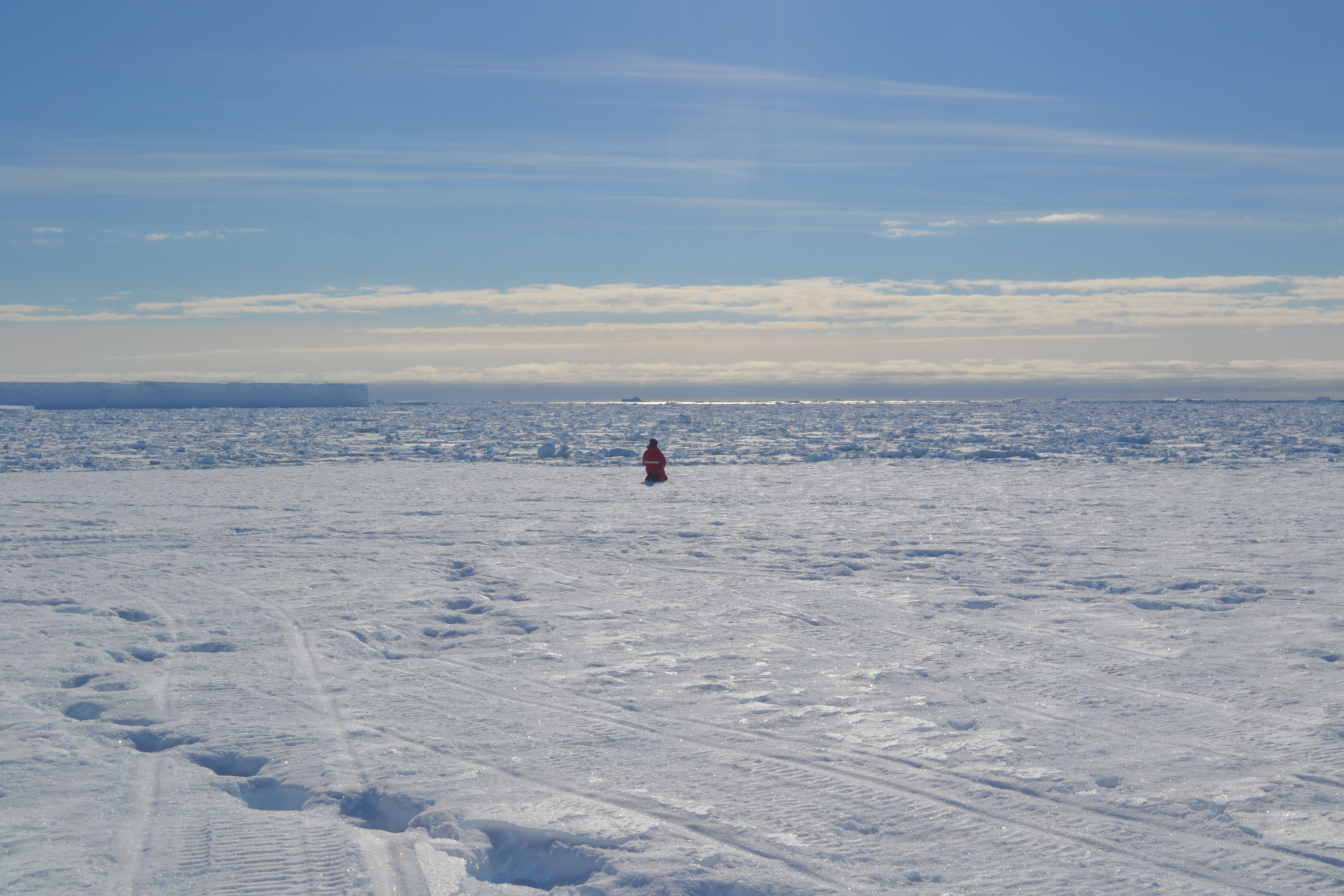 Researcher standing alone on an ice shelf at the south pole