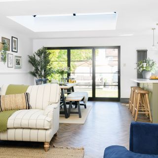 white stripey armchair in front of dining table and kitchen island