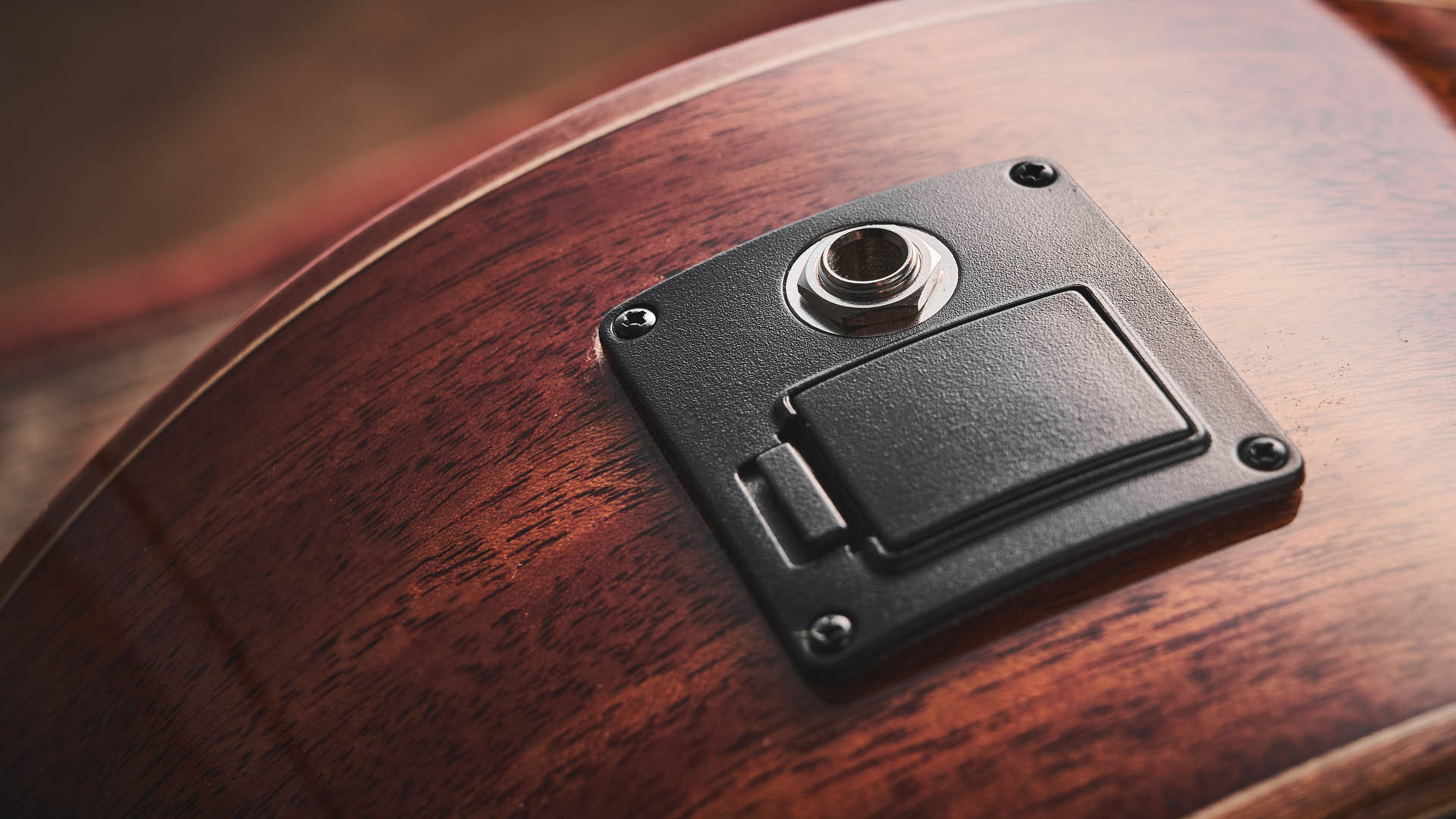 Harley Benton CLG-650SM-CE Black: the handsome but affordable cutaway acoustic isd photographed against a patterned rug on a wooden floor.