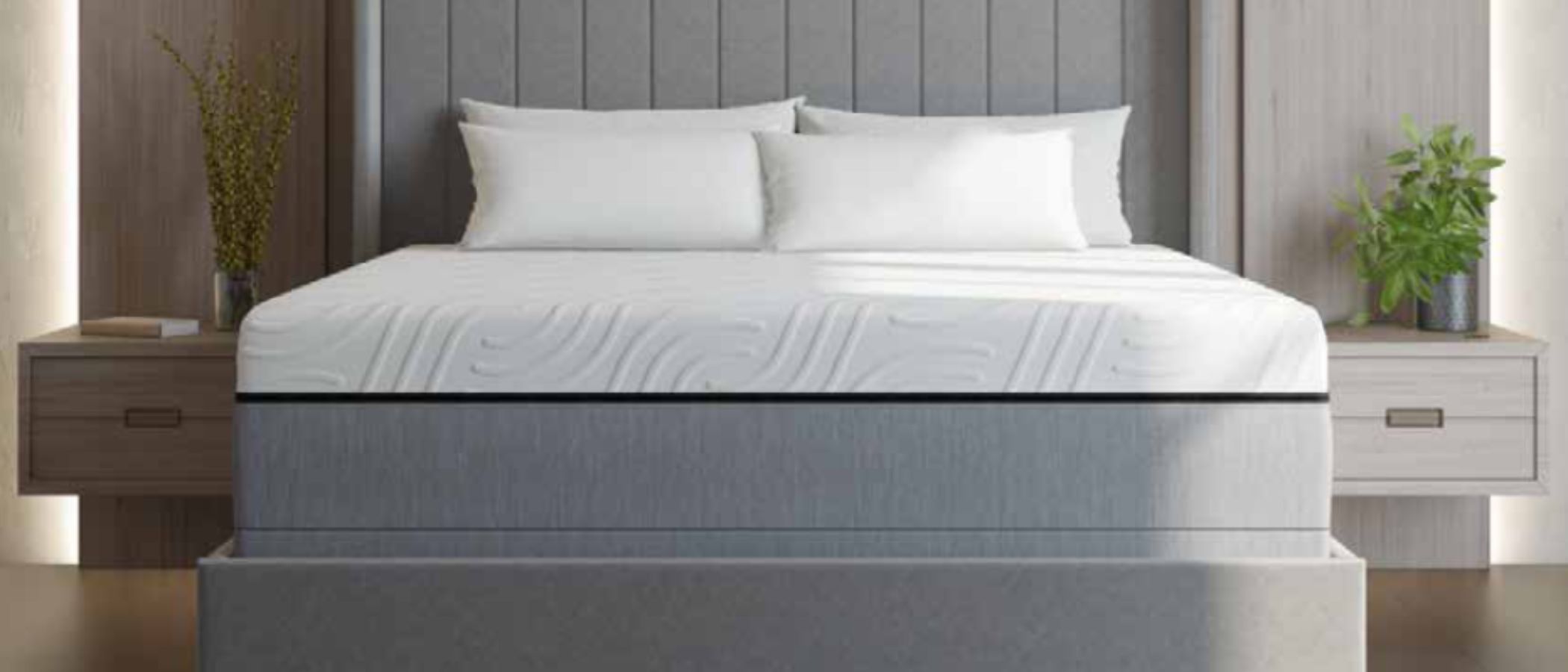 The gray and white Personal Comfort Rejuvenate smart mattress on a gray bed frame, set within a sleek and neutrally decorated bedroom