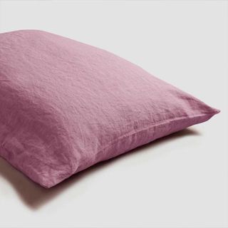 Raspberry Linen Pillowcase against a gray background.