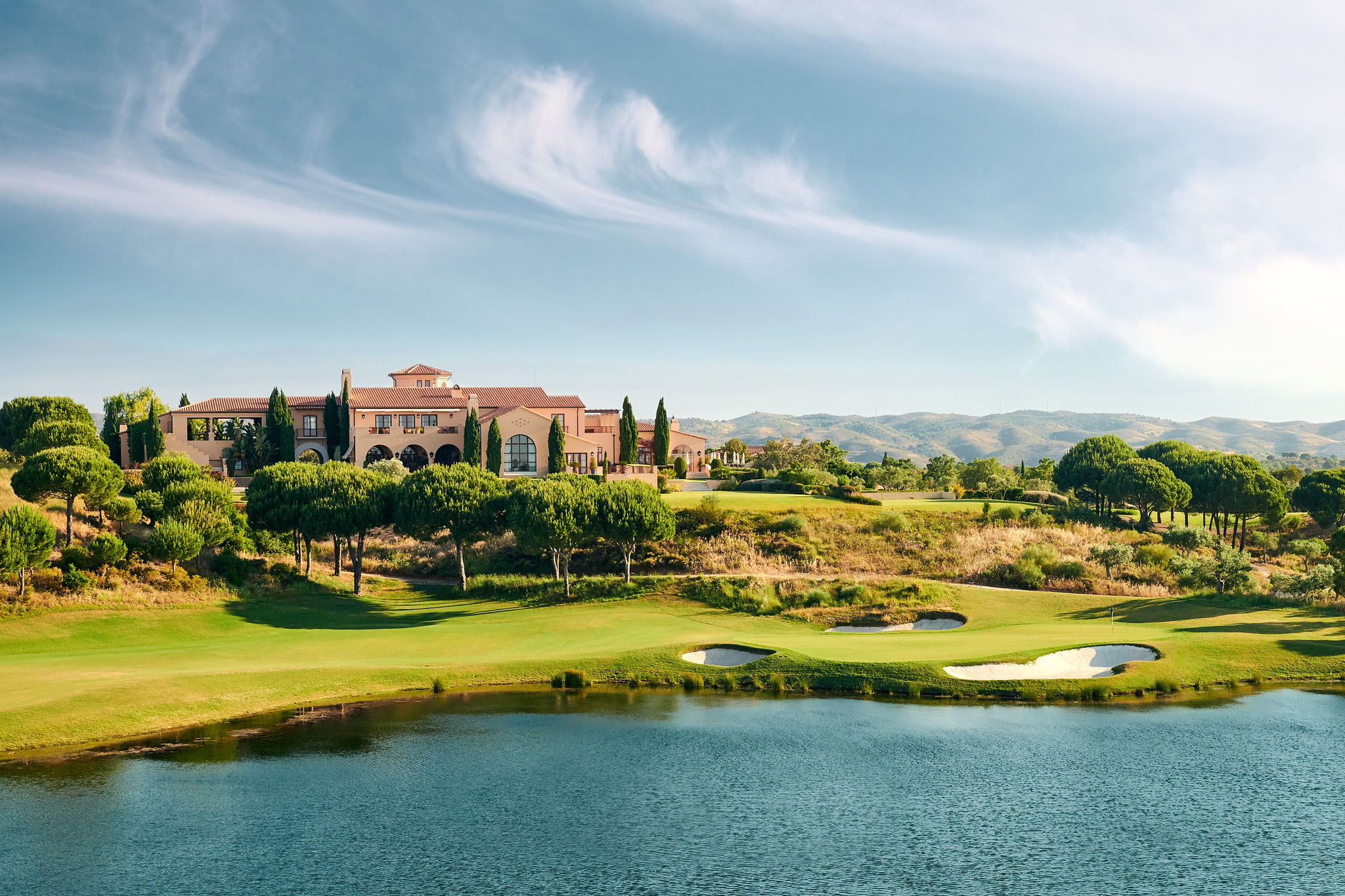 The 18th green at Monte Rei and the clubhouse beyond