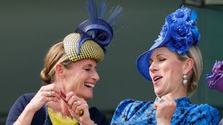Zara Tindall (r) and Dolly Maude eat wines gums whilst watching the racing from the royal box as they attend The Epsom Derby at Epsom Racecourse in 2022