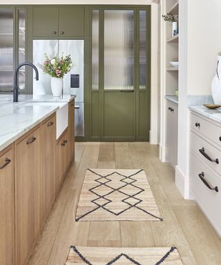 white and oak kitchen with two sisal rugs