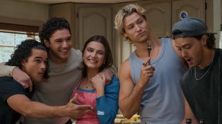 From left to right: Tucker, Garrett and Hannah posing together, Dean holding up a fork and Logan looking down. 