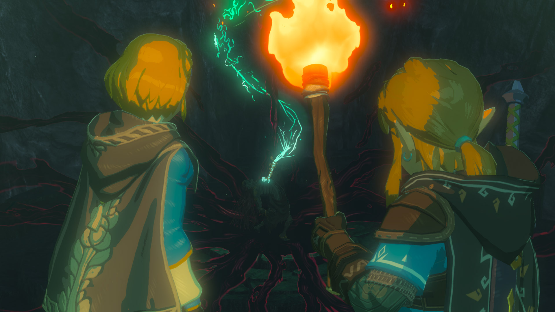 Link y Zelda con una antorcha entran en un pasadizo oscuro