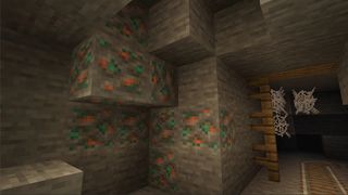 Minecraft 1.17 features - copper ore is shown in an abandoned mineshaft wall