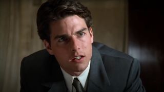 Tom Cruise sits with a nervous look on his face in The Firm.