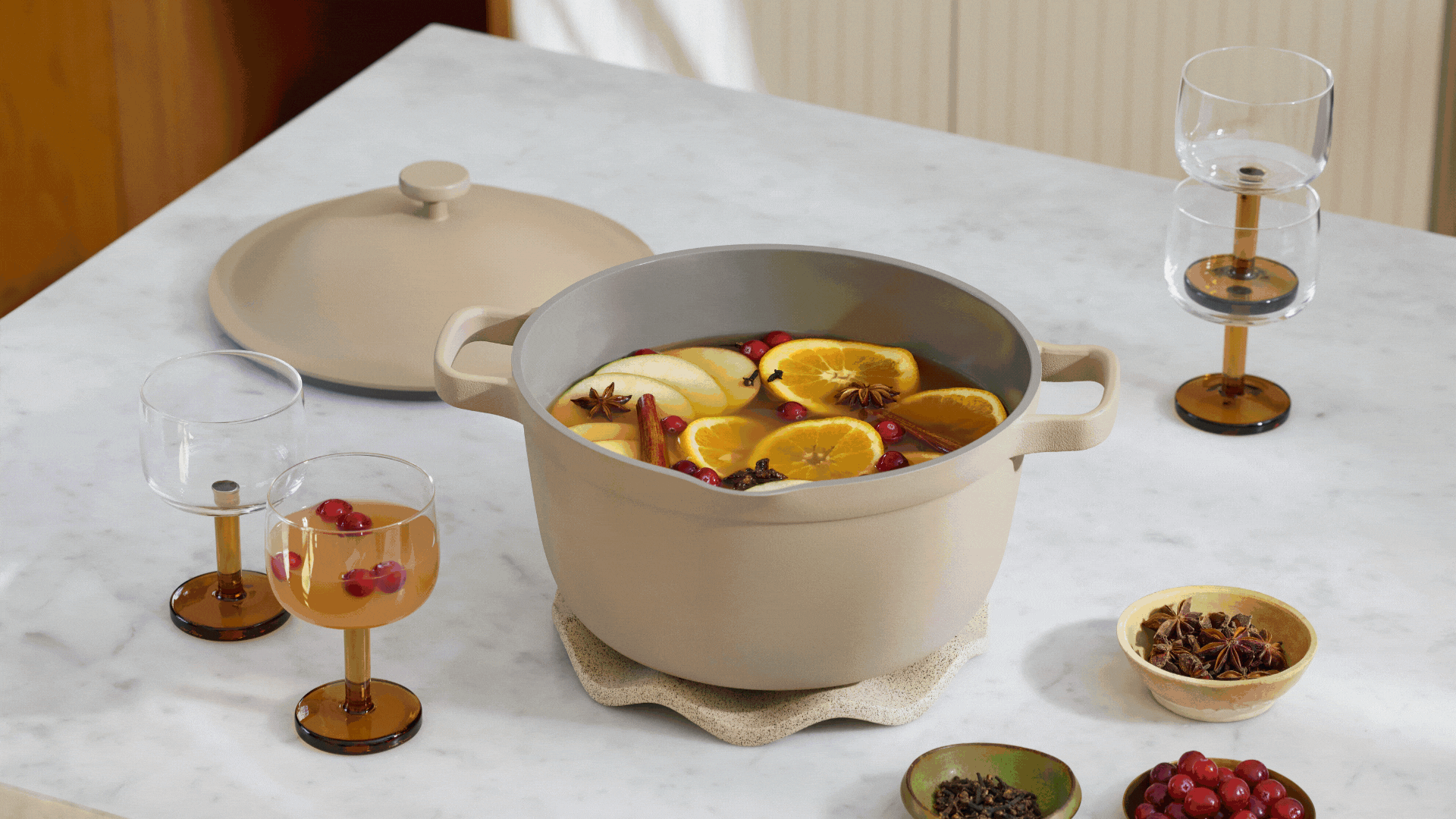 A GIF of colorful cookware in cast iron, stainless steel, and clay