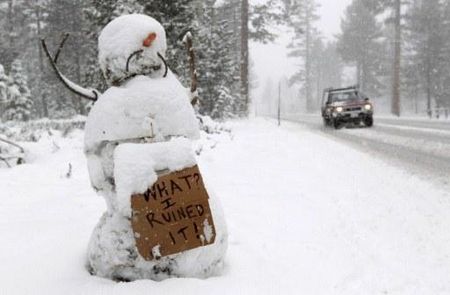 A snowman holds a sign along the race route on Highway 89 after stage one of the 2011 Amgen Tour of California from South Lake Tahoe to North Lake Tahoe was cancelled