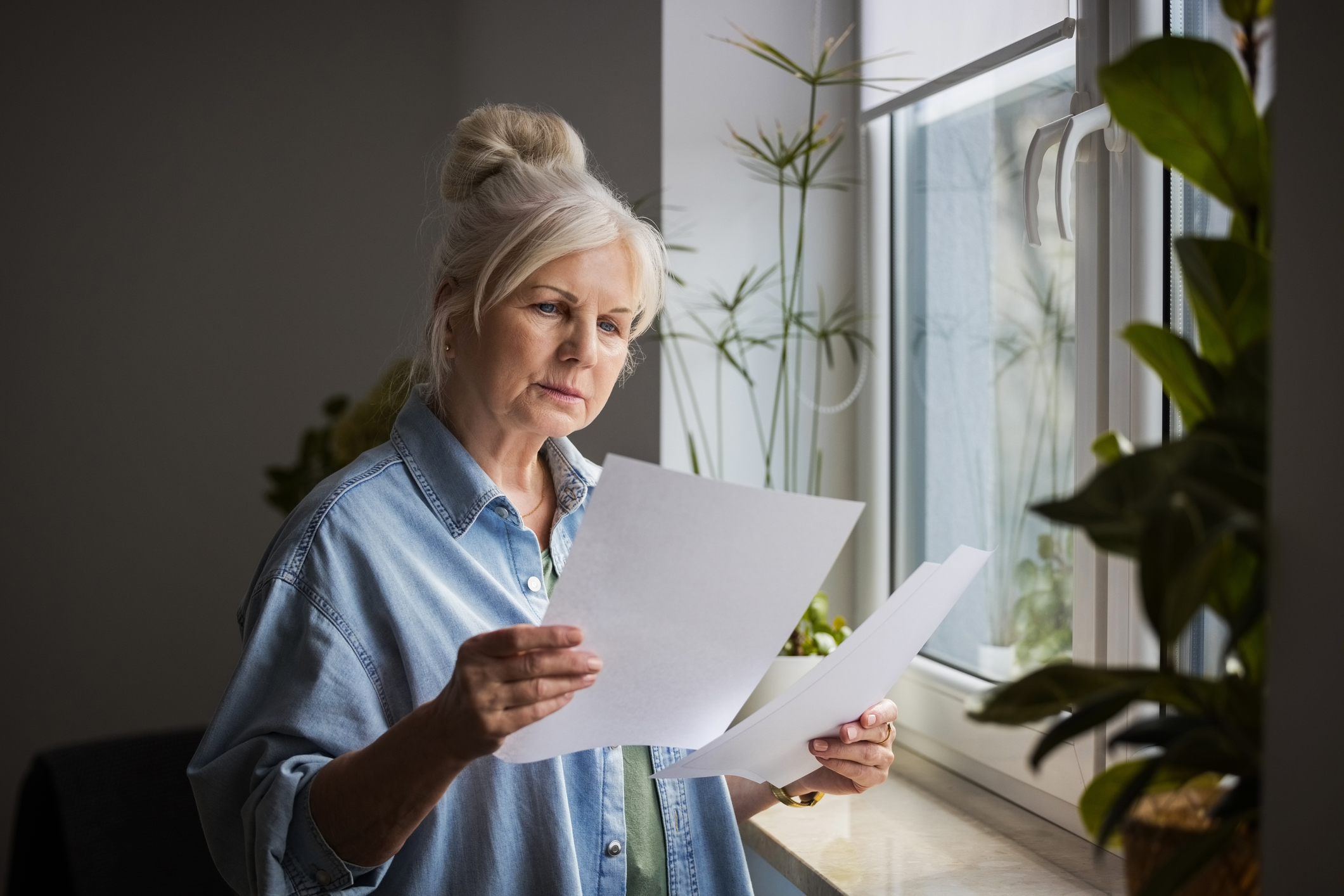 Pensioner looking over her state pension statement