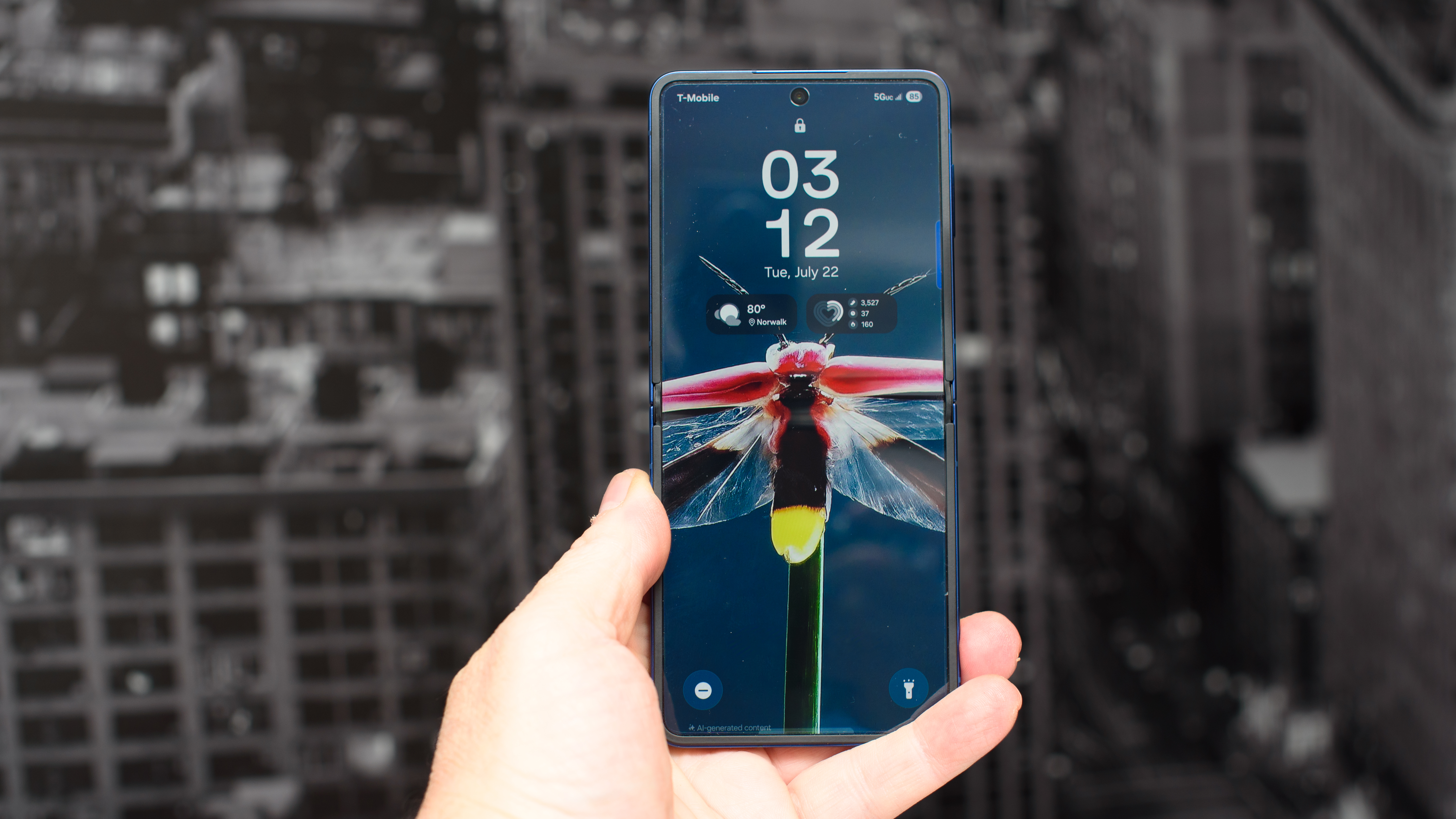 Samsung Galaxy Z Flip 7 in blue in hand showing a firefly wallpaper that was generated by AI
