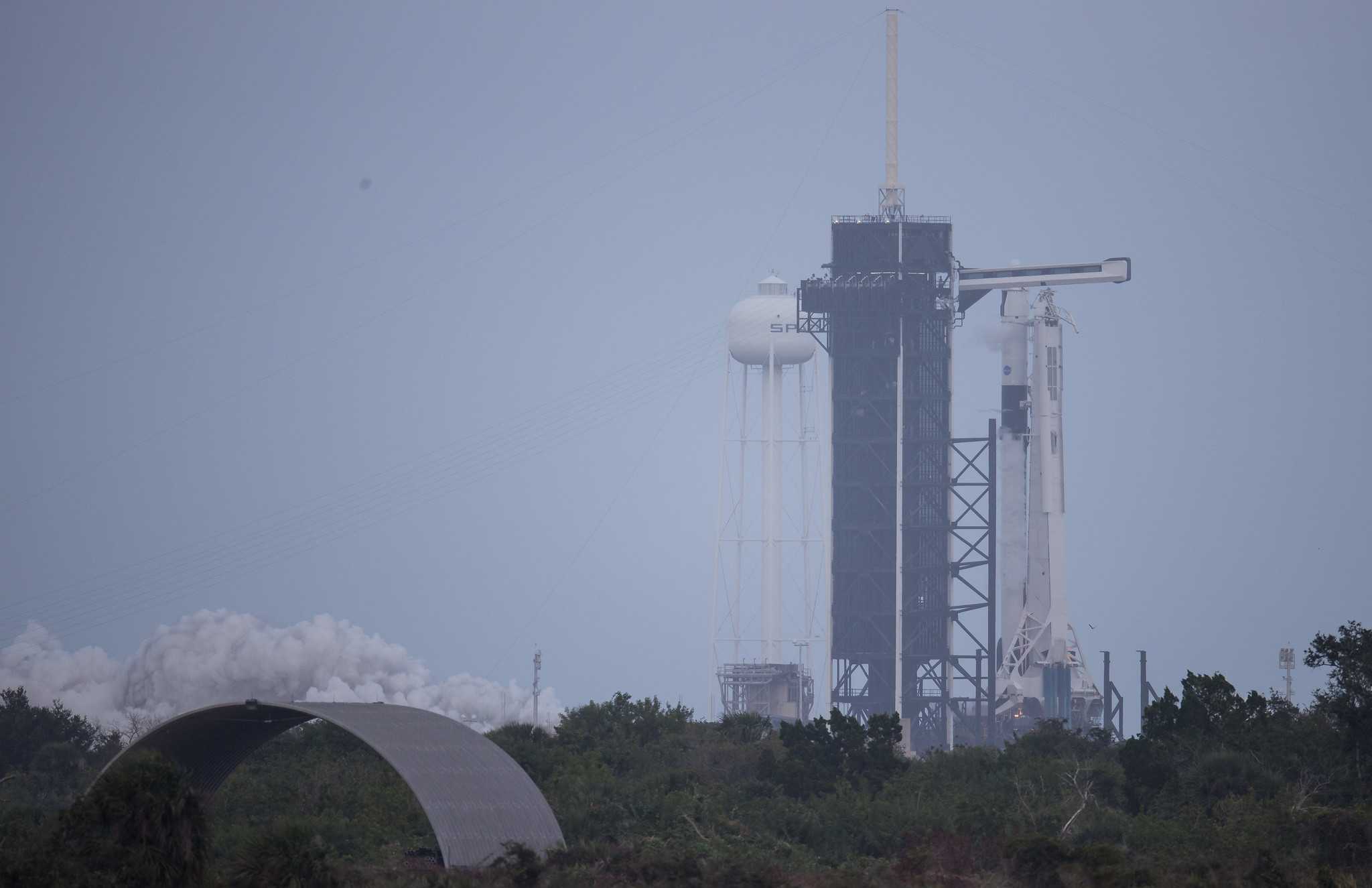 A SpaceX Falcon 9 rocket test fires its first-stage engines briefly atop Pad 39A at NASA's Kennedy Space Center in Cape Canaveral, Florida on Nov. 11, 2020. The rocket will launch the Crew-1 astronaut mission for NASA on Nov. 14.
