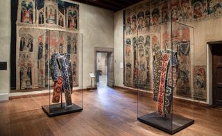 Garments showcased at the Met Cloisters in colours blue and red.