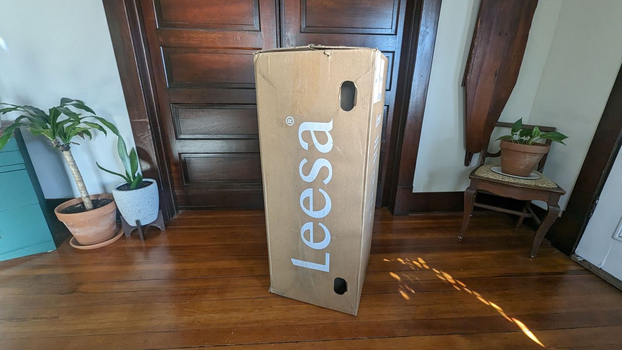 Leesa Oasis Chill Hybrid review image shows the mattress in a cardboard box in our lead tester's bedroom