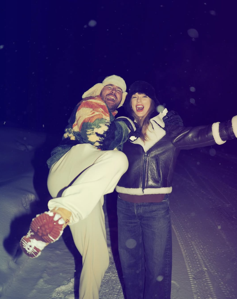 Travis and Taylor Swift cuddle in the snow