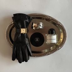 Flatlay of beauty products and accessories on a silver tray