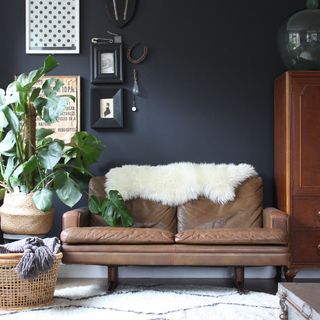 living room with indigo wall sofa set and brown cabinet