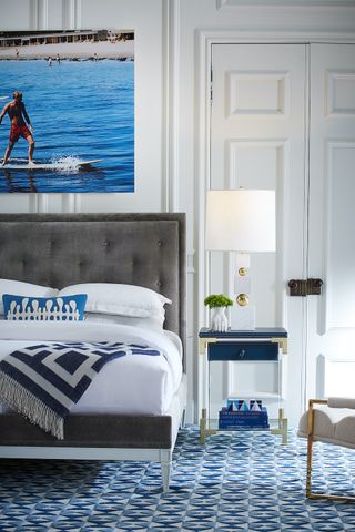 bedroom ideas for men, blue and white bedroom with art by Jonathan Adler