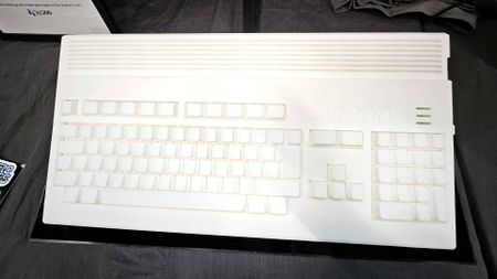 White Amiga A1200 Prototype model sitting on black table at Gamescom 2025 booth.