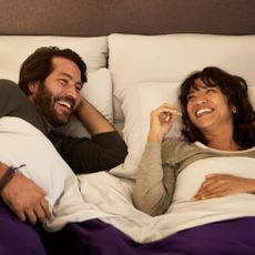 A couple enjoying a Purple mattress, duvet, and pillow