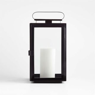 black outdoor lantern with white pillar candle