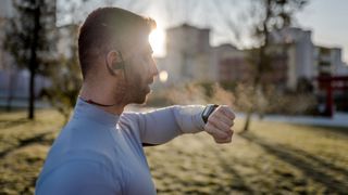 Man looking at fitness tracker to monitor cardiovascular endurance 