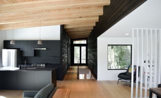 Interior of Swift Cabin, Washington, by Ment Architecture with wood ceiling and floor