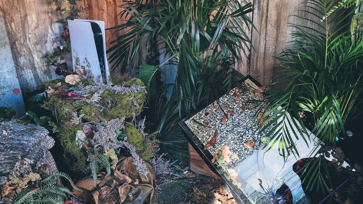 A shot of a PS5 and wrecked TV in an overgrown set