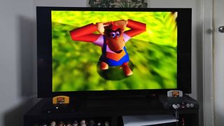 HDMI modded Nintendo 64 connected to LG OLED C4 TV with Donkey Kong 64 gameplay on screen featuring Lanky Kong.