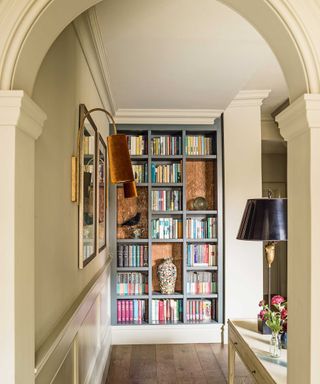 hallway with archway and bookshelves