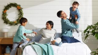 Family sitting on a Purple mattress