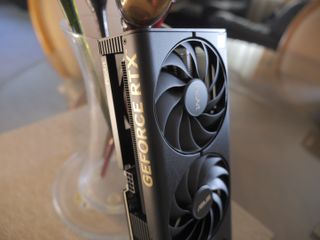 An ASUS ProArt RTX 4060 Ti graphics card sitting on a desk