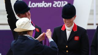 LONDON, ENGLAND - JULY 31: Zara Phillips is presented a silver medal by her mother, Princess Anne, Princess Royal after the Eventing Team Jumping Final Equestrian event on Day 4 of the London 2012 Olympic Games at Greenwich Park on July 31, 2012 in London, England.