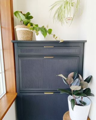 A dark blue cabinet with gold handles