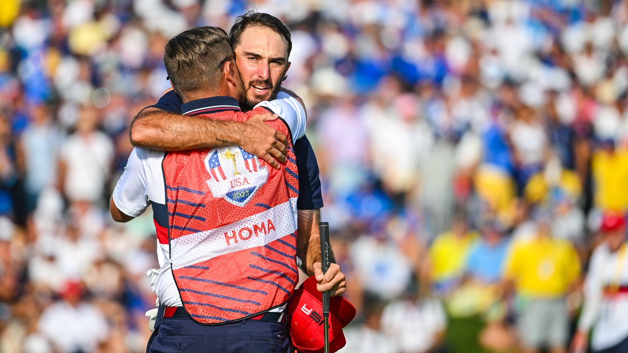 Max Homa hugs his caddie after a Ryder Cup match