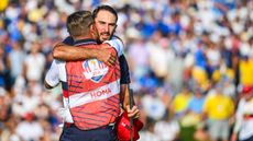 Max Homa hugs his caddie after a Ryder Cup match