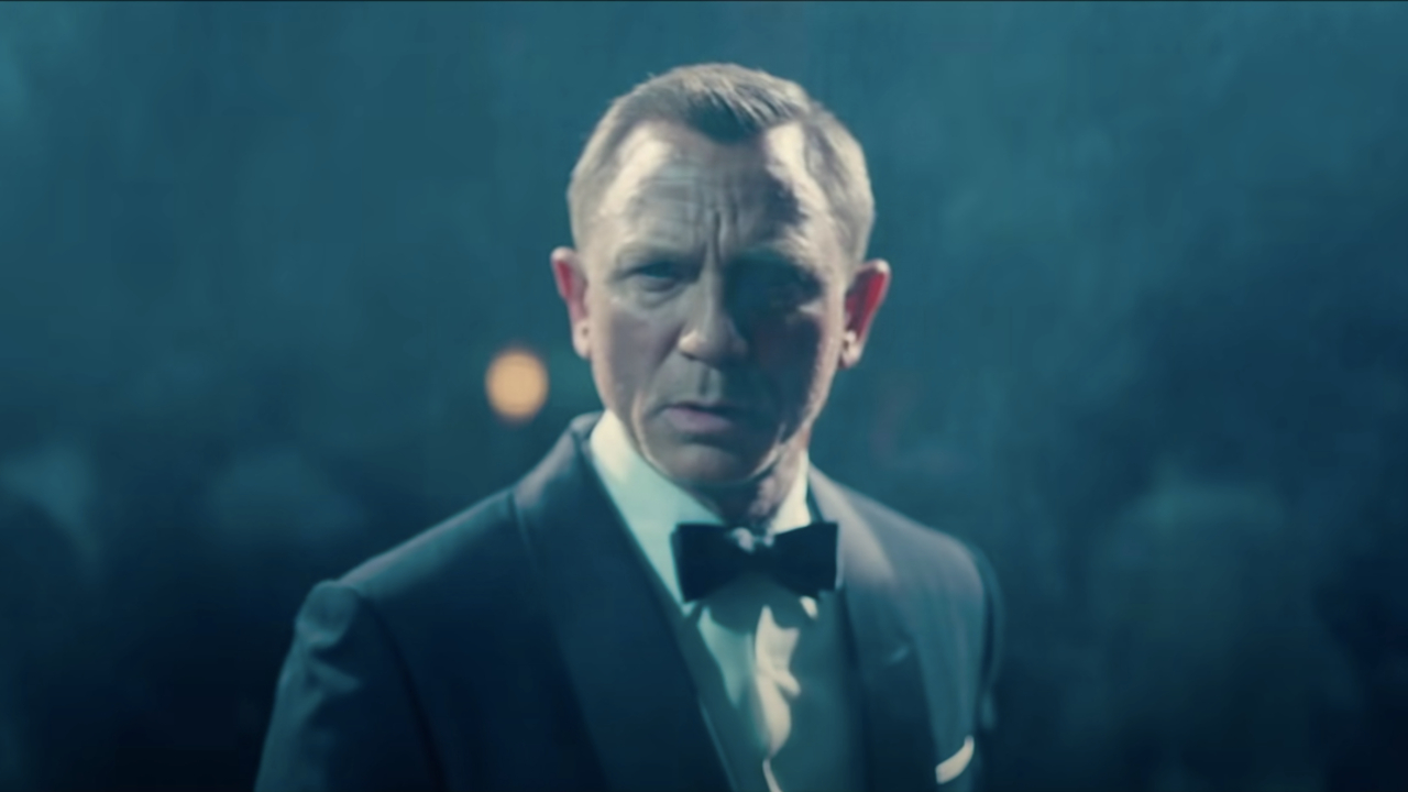 Daniel Craig stands confused in a cloud of mist in No Time To Die.