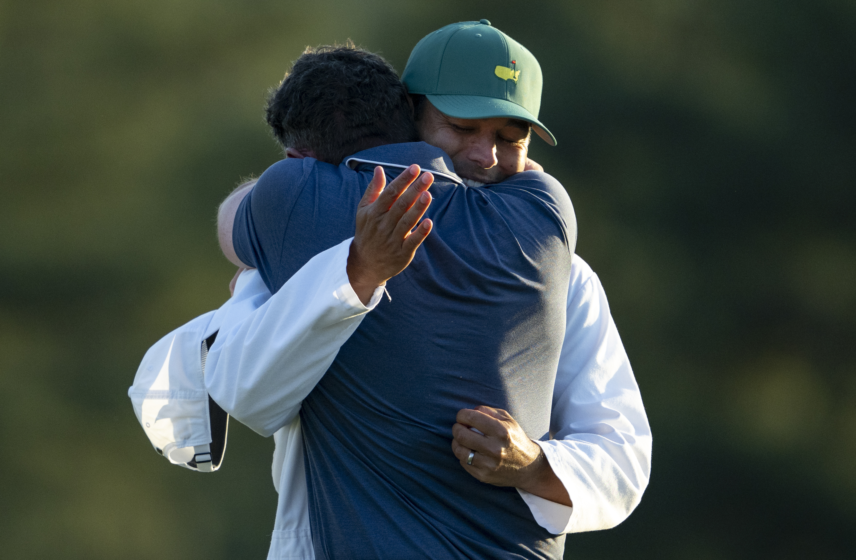 Masters champion Rory McIlroy of Northern Ireland celebrates with is caddie Harry Diamond after winning the Masters in a sudden death playoff on the No. 18 green at Augusta National Golf Club, Sunday, April 13, 2025. (Photo by Logan Whitton/Augusta National/Getty Images)