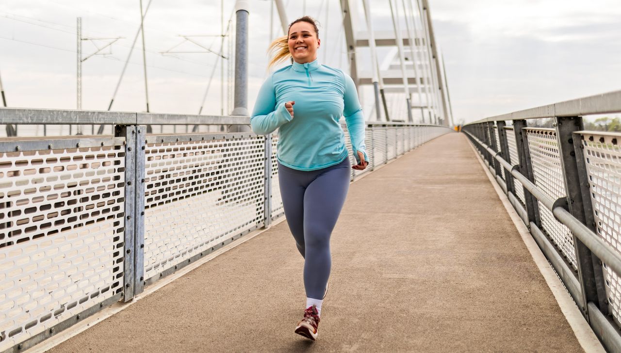 Woman running along bridge