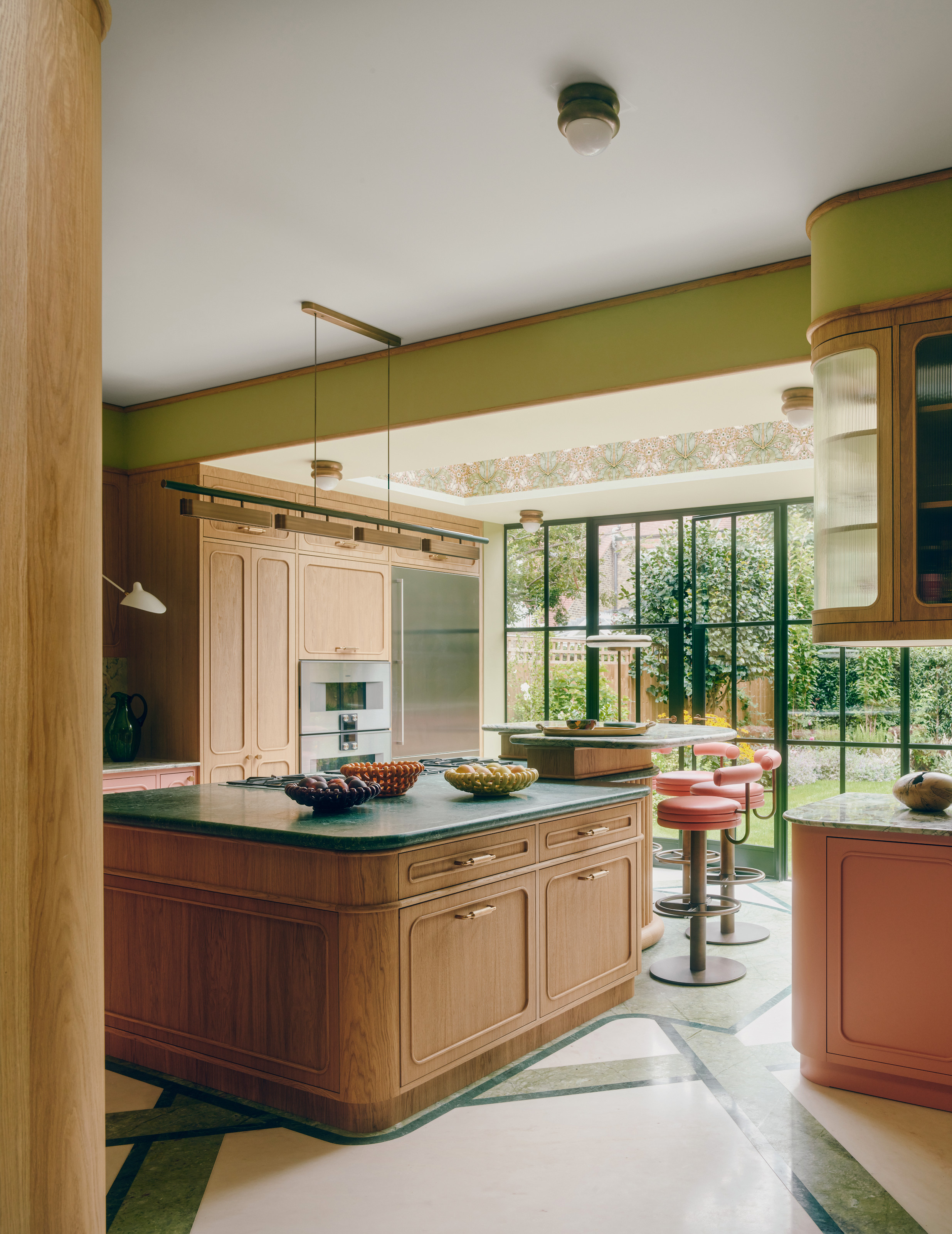 Kitchen with lime green walls, cream and white stone floor, oak cabinetry and emerald green countertops