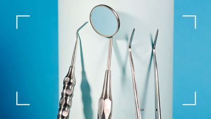 A range of dental implements, including a mirror, on white and blue background to represent how often should you go to the dentist