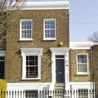 house with exposed brick walls and white windows