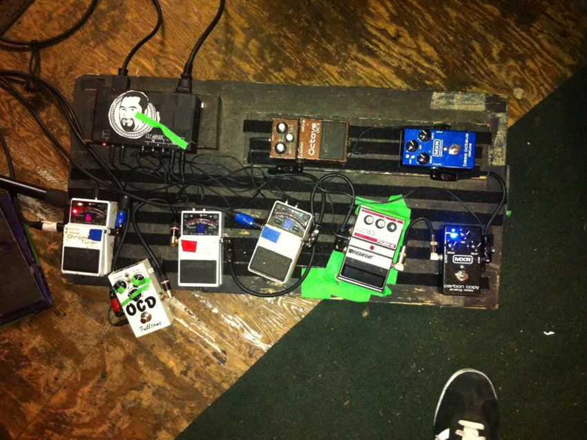 Bottom row, left to right: Boss Chromatic Tuner used for switching the Matchless, OCD distortion pedal, Boss tuner used for switching the Vox, Boss tuner for switching the Ampeg, DOD phaser, MXR Carbon Copy delay. Top row, left to right: Boss octave pedal for the bass pickup, MXR bass octave pedal.
