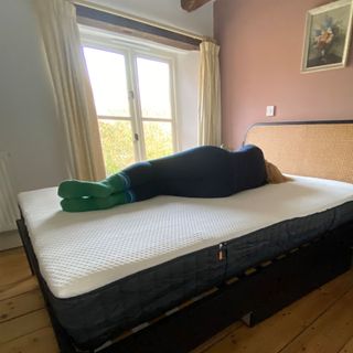 The Emma Hybrid Original mattress being tested by a female reviewer