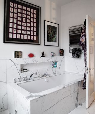 white bathroom with bathtub and wall picture