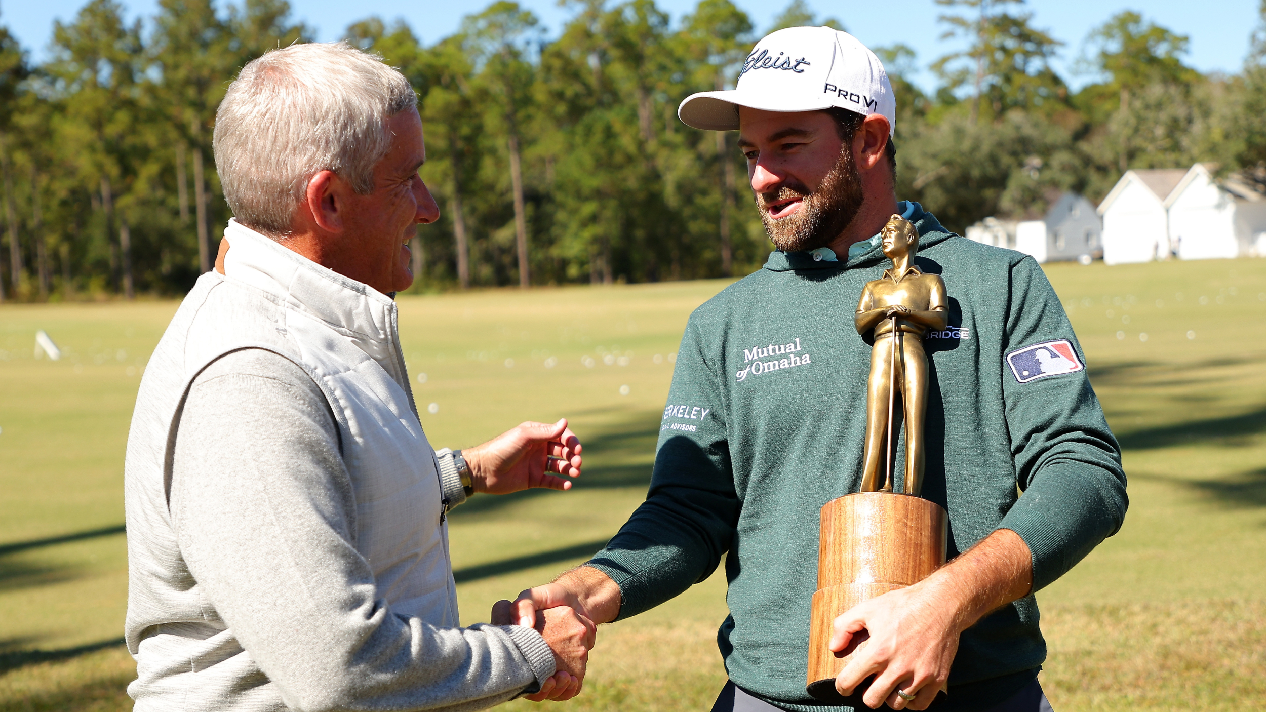 Jay Monahan and Cameron Young with the PGA Tour Rookie of the Year award